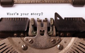 What's Your Story typed on paper in old-fashtioned typewriter