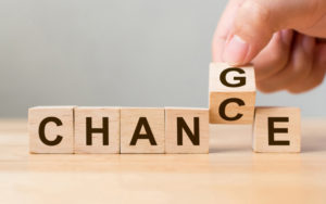 Blocks spelling out chance with man flipping C to G to spell change instead
