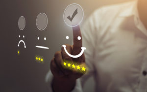 A man indicates a good reputation by selecting a smiley face and a five-star rating
